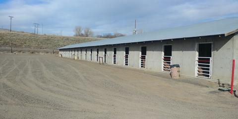 A row of buildings sitting next to each other on a dirt road.