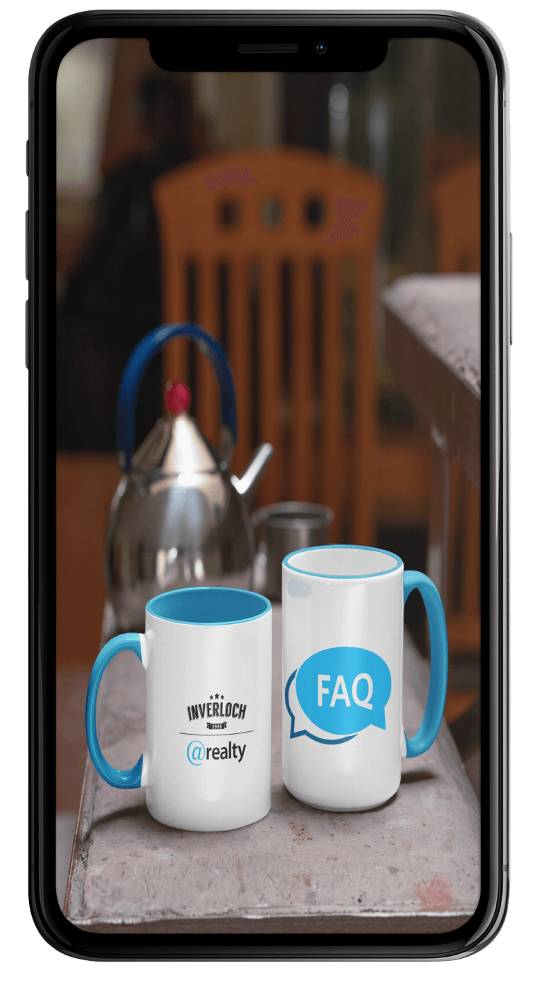 Two coffee mugs are sitting on a table next to a kettle.