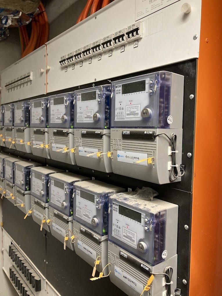 Electric Meters Mounted On A Panel, With Circuit Breakers Above — J T Walker Solar & Electrical In Taree, NSW