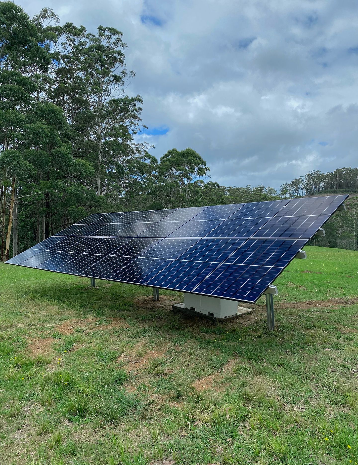 A Large Solar Panel Is Sitting In The Middle Of A Grassy Field — J T Walker Solar & Electrical In Forster - Tuncurry, NSW