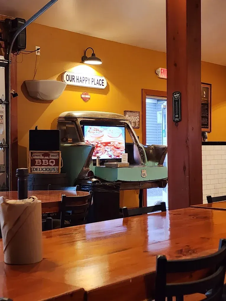 Restaurant interior with a wooden bar, teal truck-shaped counter, and