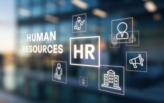 HR graphic with icons over a blurred modern office building.