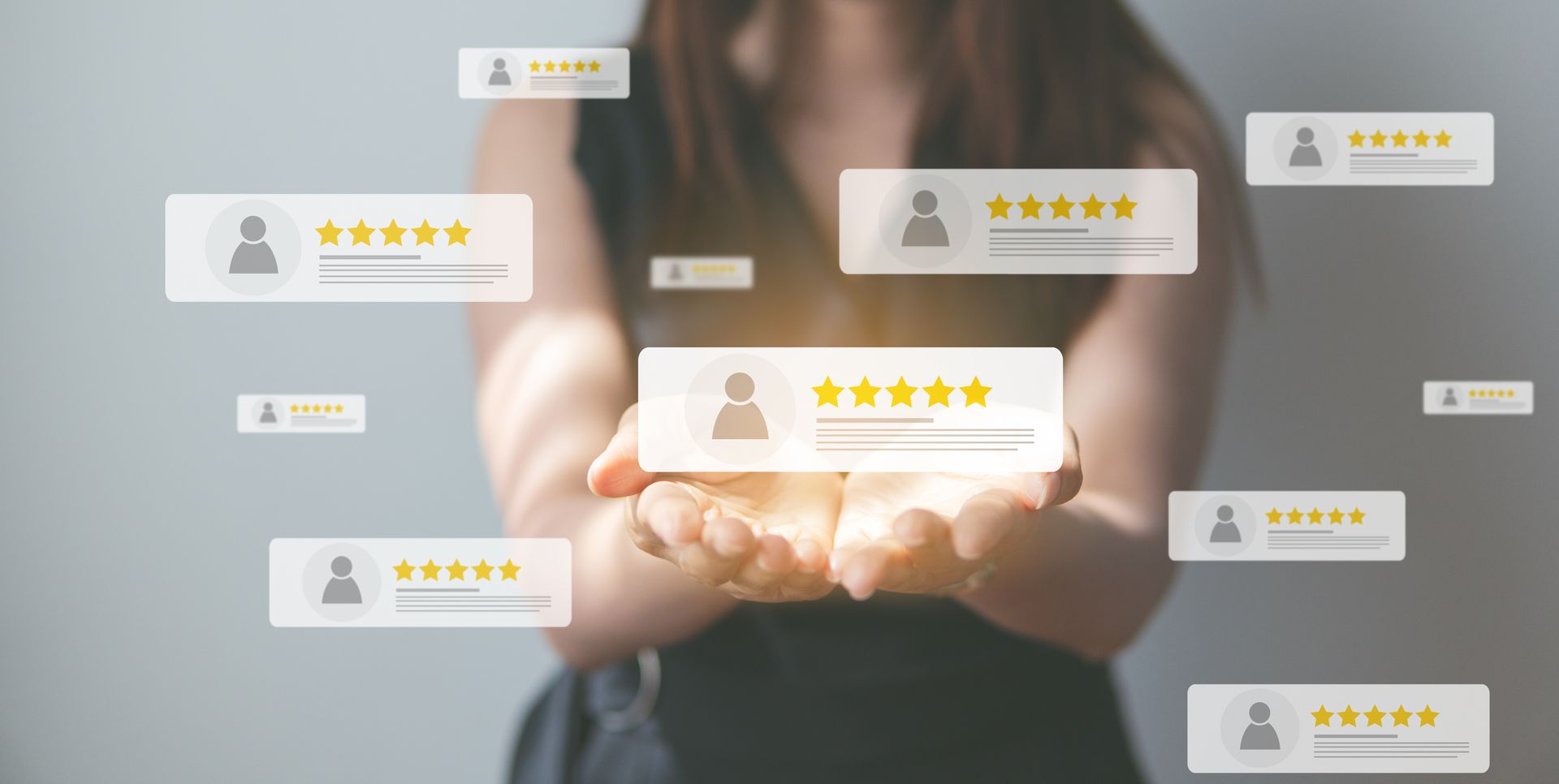 Businesswoman holding glowing digital review ratings and star icons in front of her hands