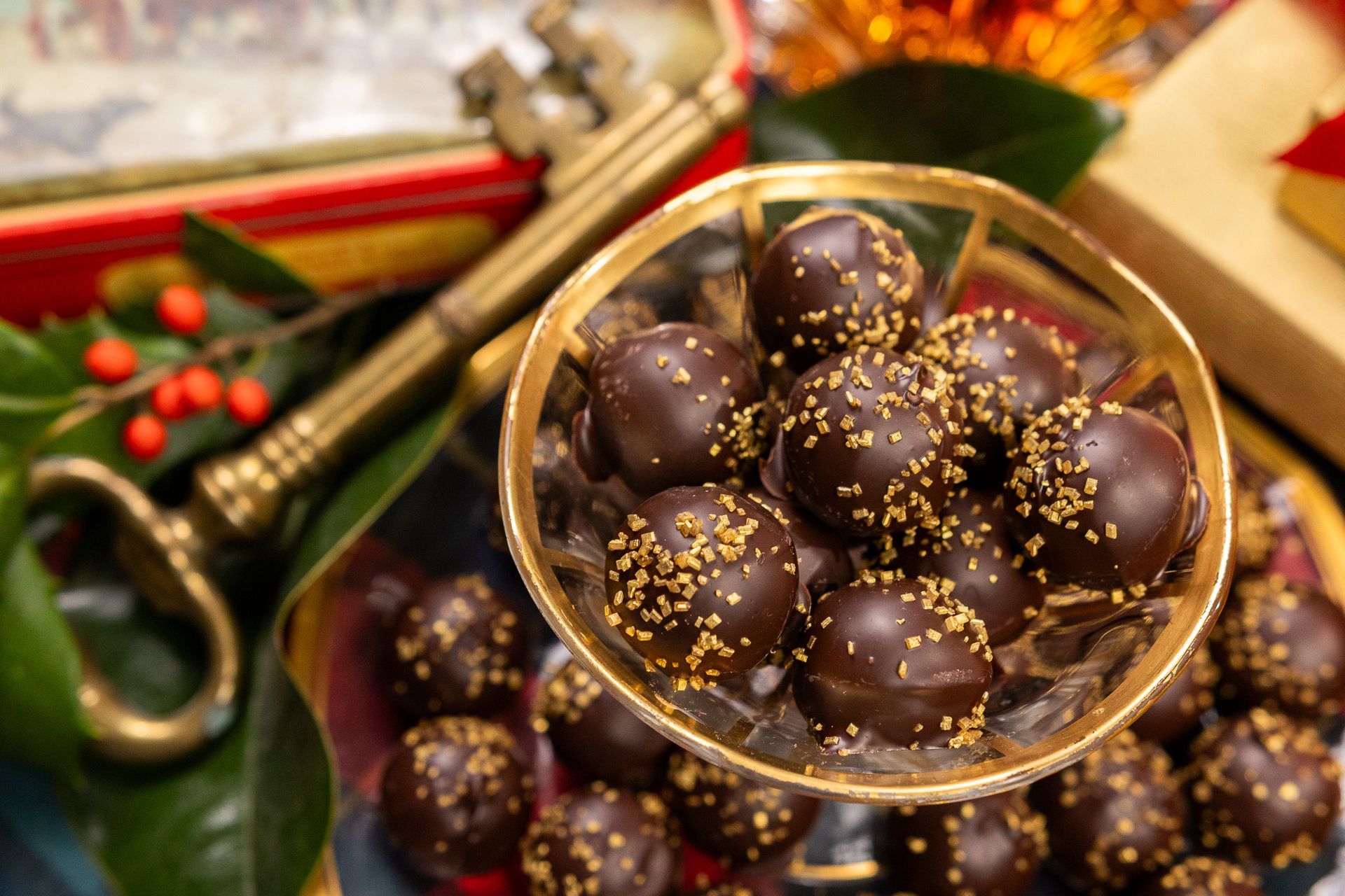 Dark chocolate-covered candies in a tight, overlapping cluster; shiny, brown.
