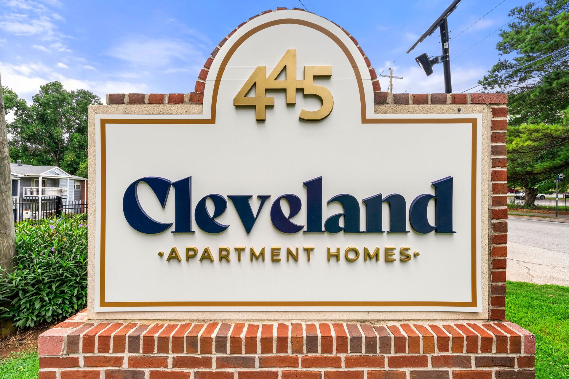 Cleveland Apartment Homes sign on a brick monument with the number 445 above it