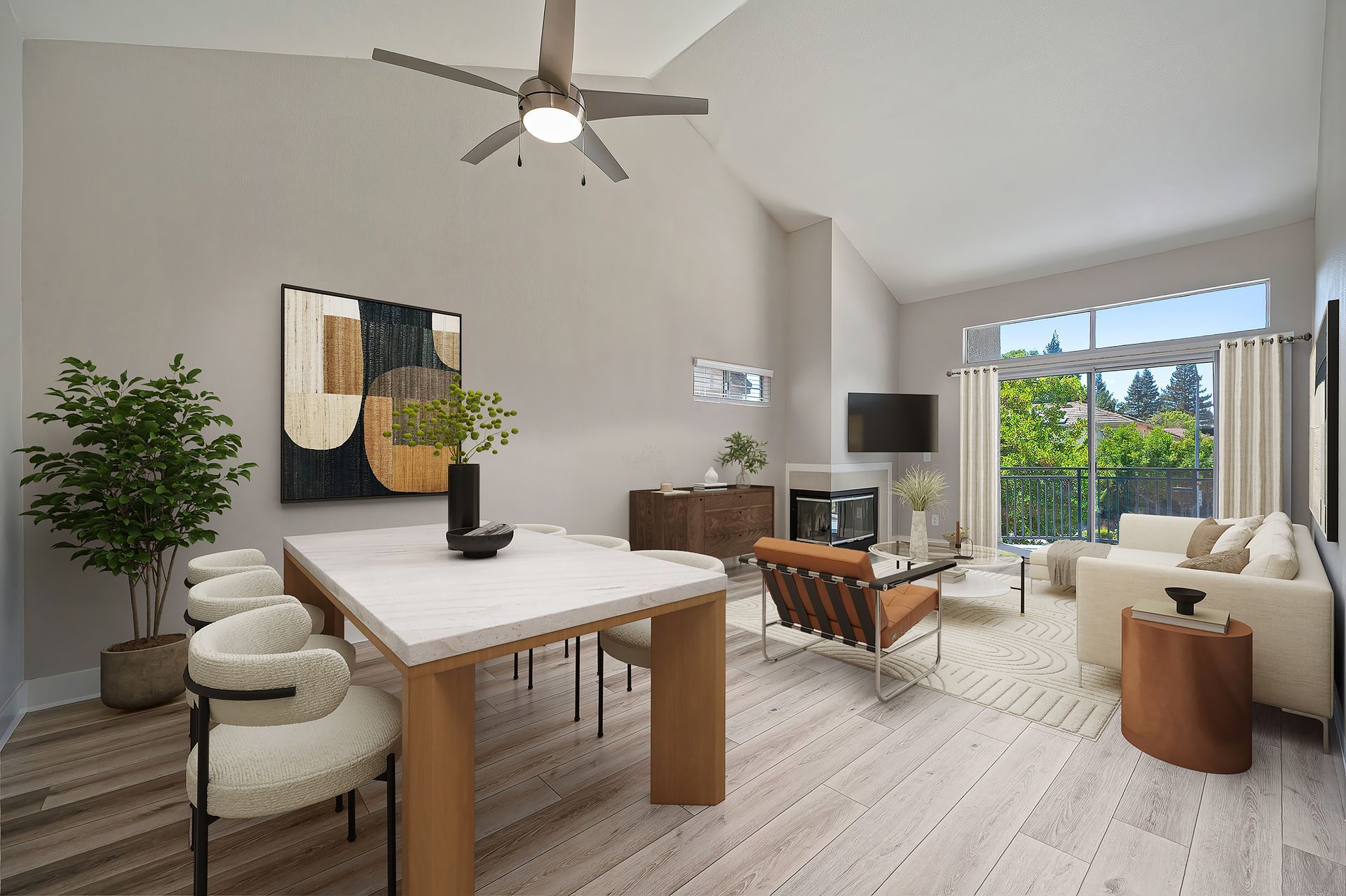 Bright modern living-dining room with white furniture, wood accents, and large windows opening to greenery
