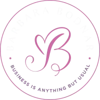 Pink circular logo with stylized “PB” and the words “Business is anything but usual” around the edge