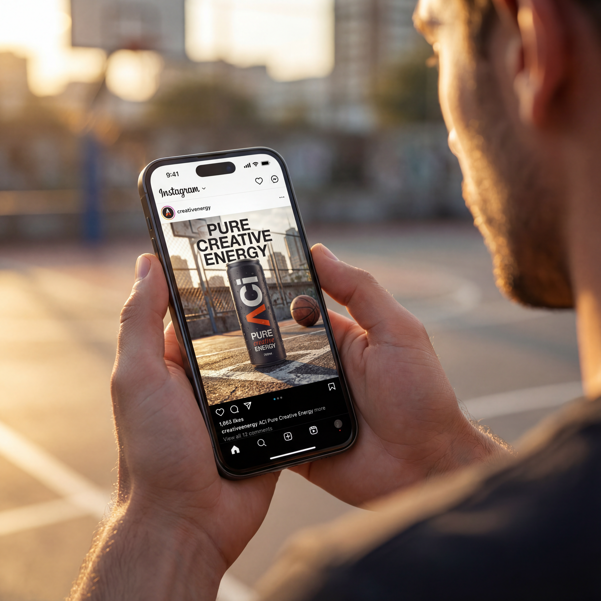 Person holding phone showing Instagram ad for energy drink; basketball court background.