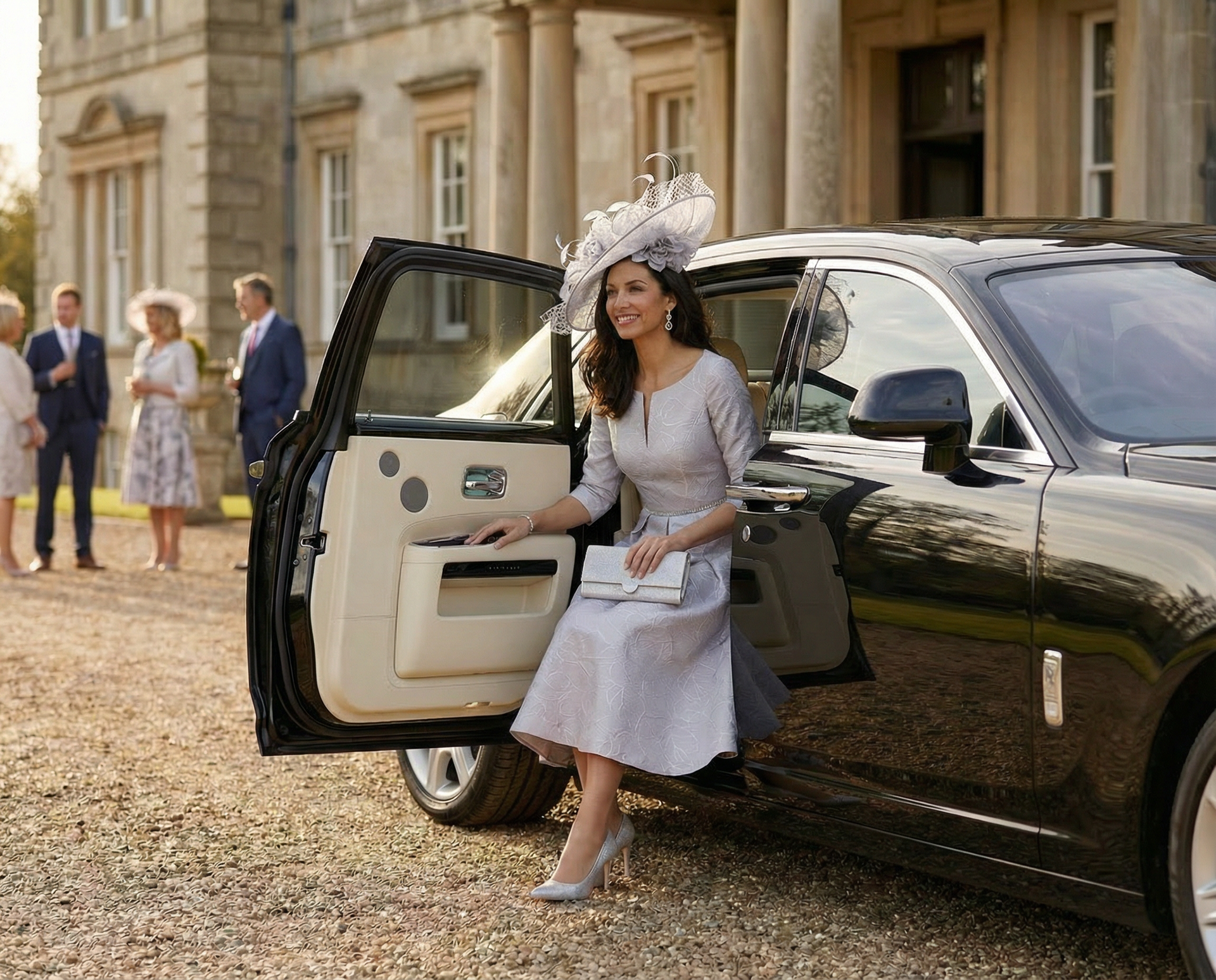 Woman in a light gray dress and hat steps from a black luxury car outside a grand stone building.