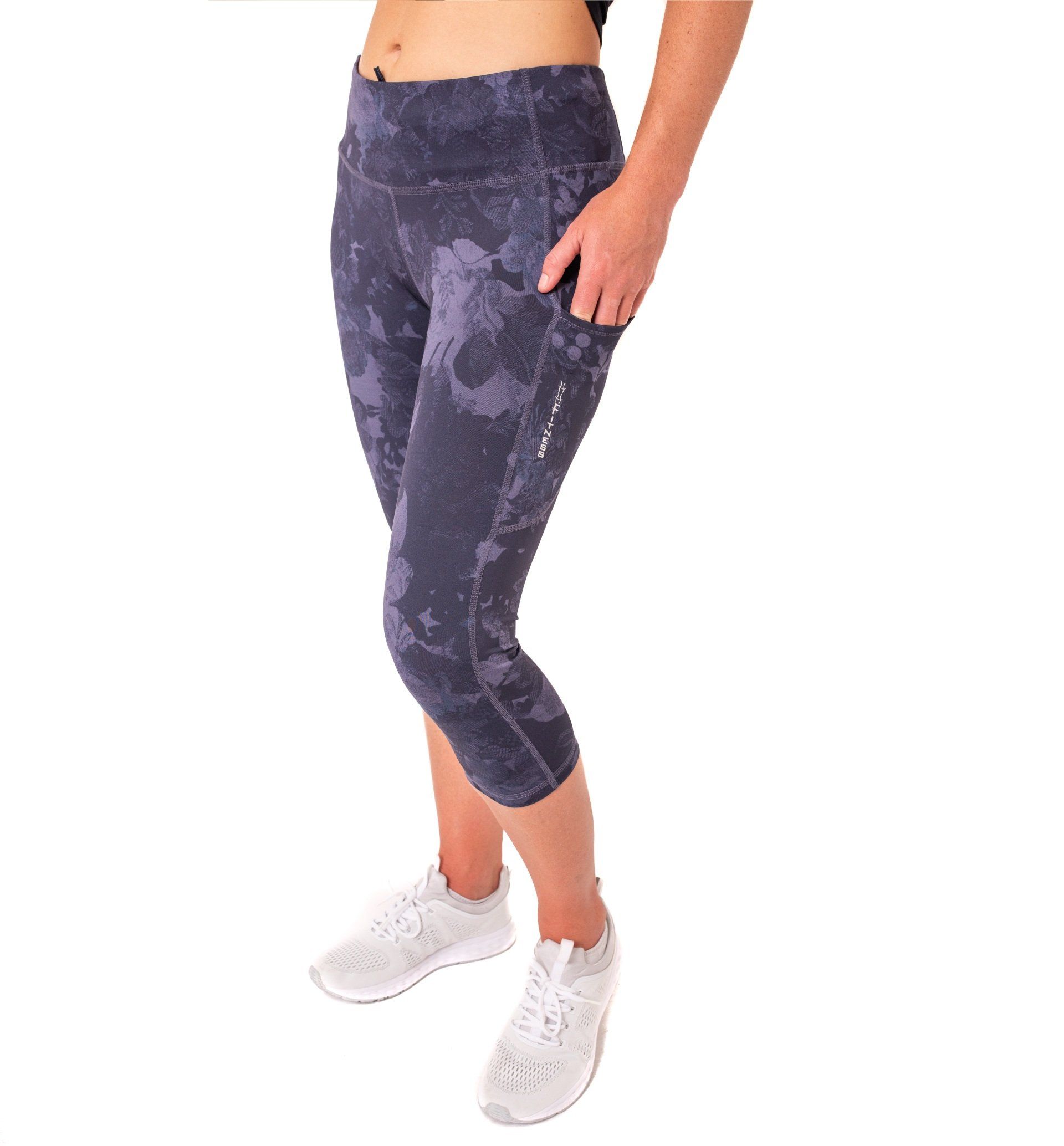 lady in cropped patterned leggings with hand in large pocket. 