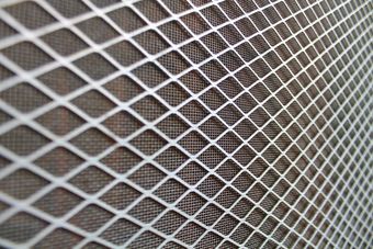 Close-Up of A White Wire Mesh Fence with Diagonal Crisscross Pattern — Glass Installations & Repairs in Gympie, QLD