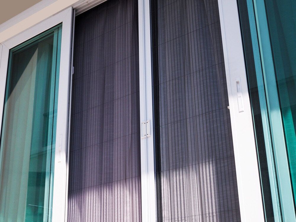 White-Framed Windows with Closed Dark Curtains and Turquoise Glass Panels — Glass Installations & Repairs in Charters Towers, QLD