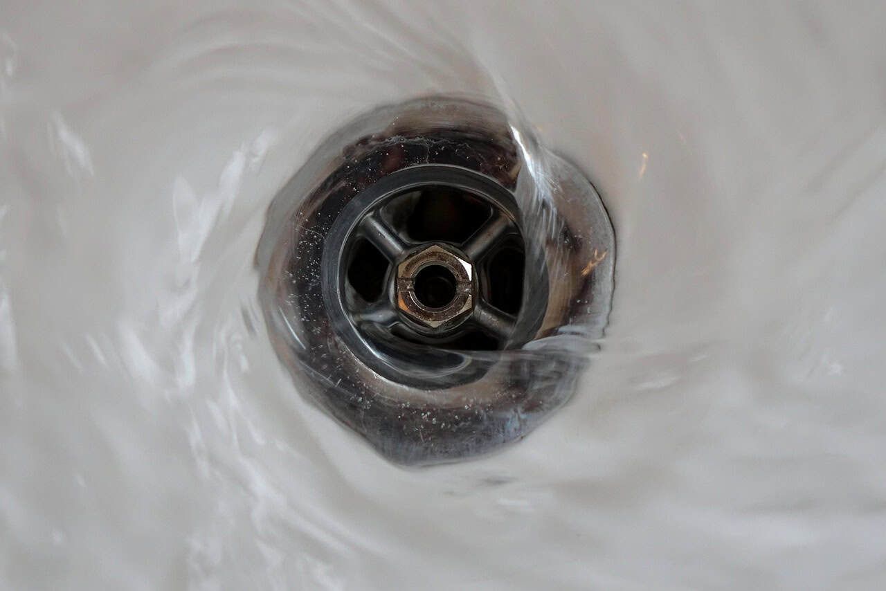 bathroom drain with water flowing in