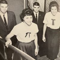 A group of people are standing next to each other in a black and white photo.