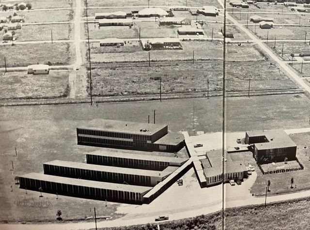 A black and white photo of a row of buildings
