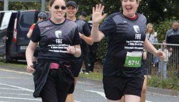 A group of women are running a marathon together.