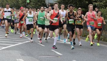 A group of people are running a marathon on a road.