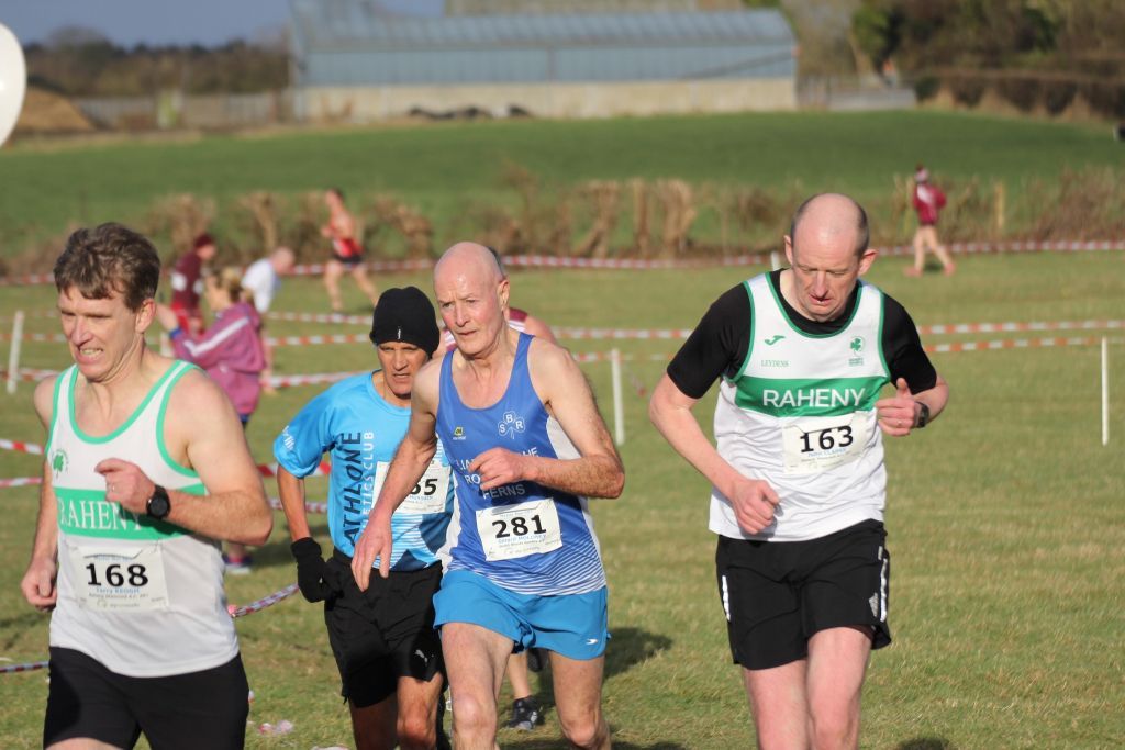 A group of men are running in a race and one of them has the number 261 on his shirt