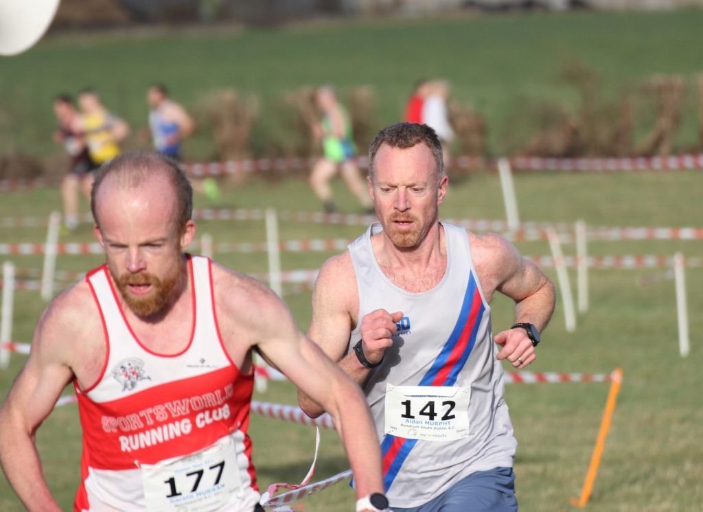 Two men are running in a race and one has the number 142 on his shirt