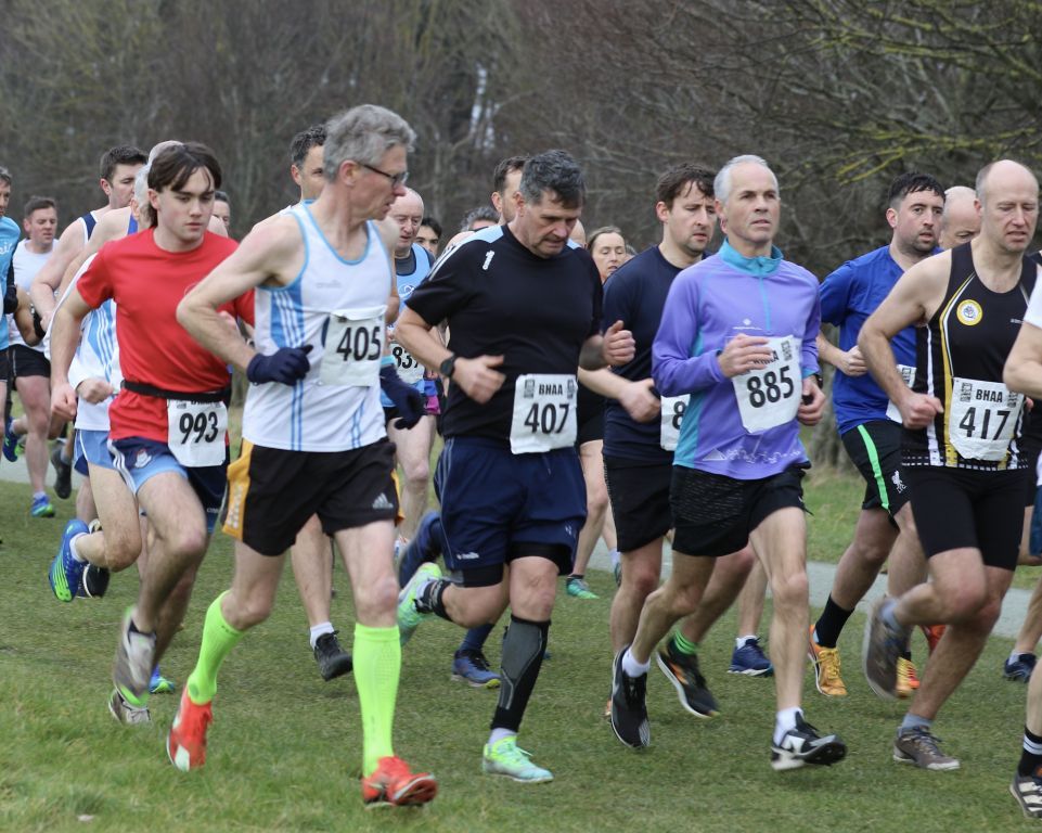A group of men are running a race and one of them has the number 407 on his shirt