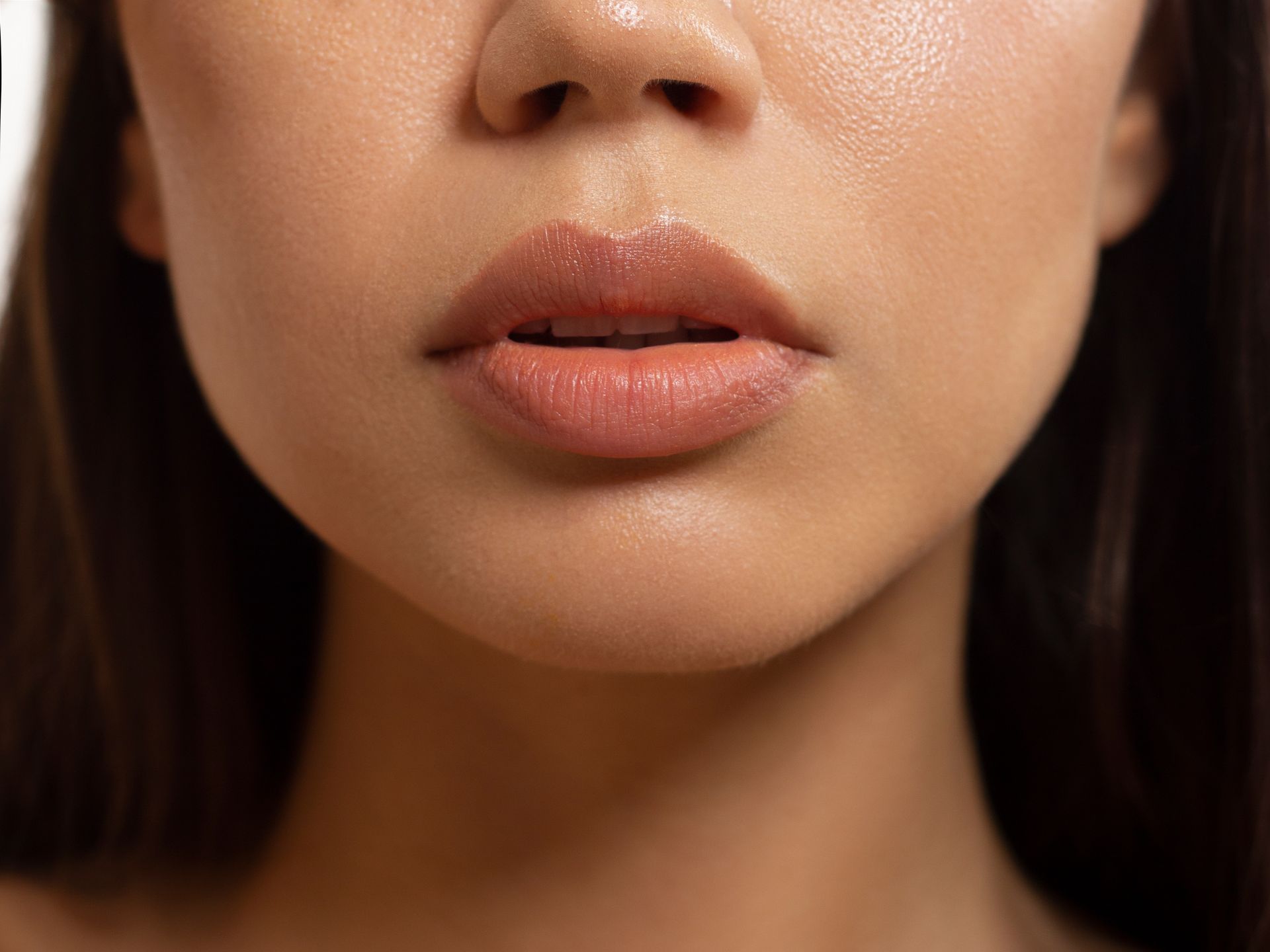 A close up of a woman 's face with her mouth open.
