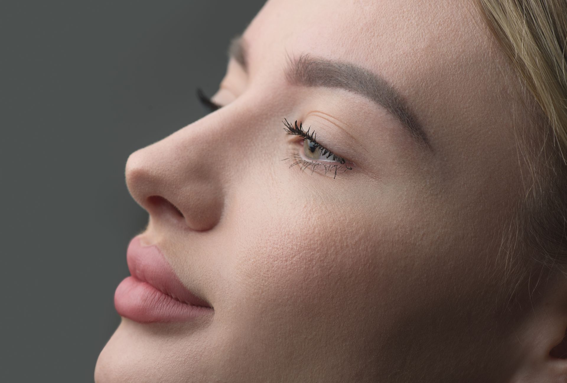 A close up of a woman 's eyes and nose without makeup.