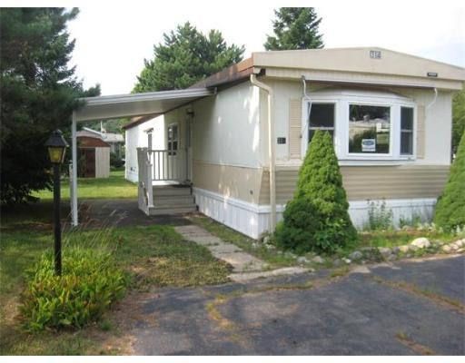 A mobile home with a sign on the window that says 