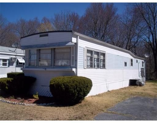 A white mobile home with a satellite dish on the roof