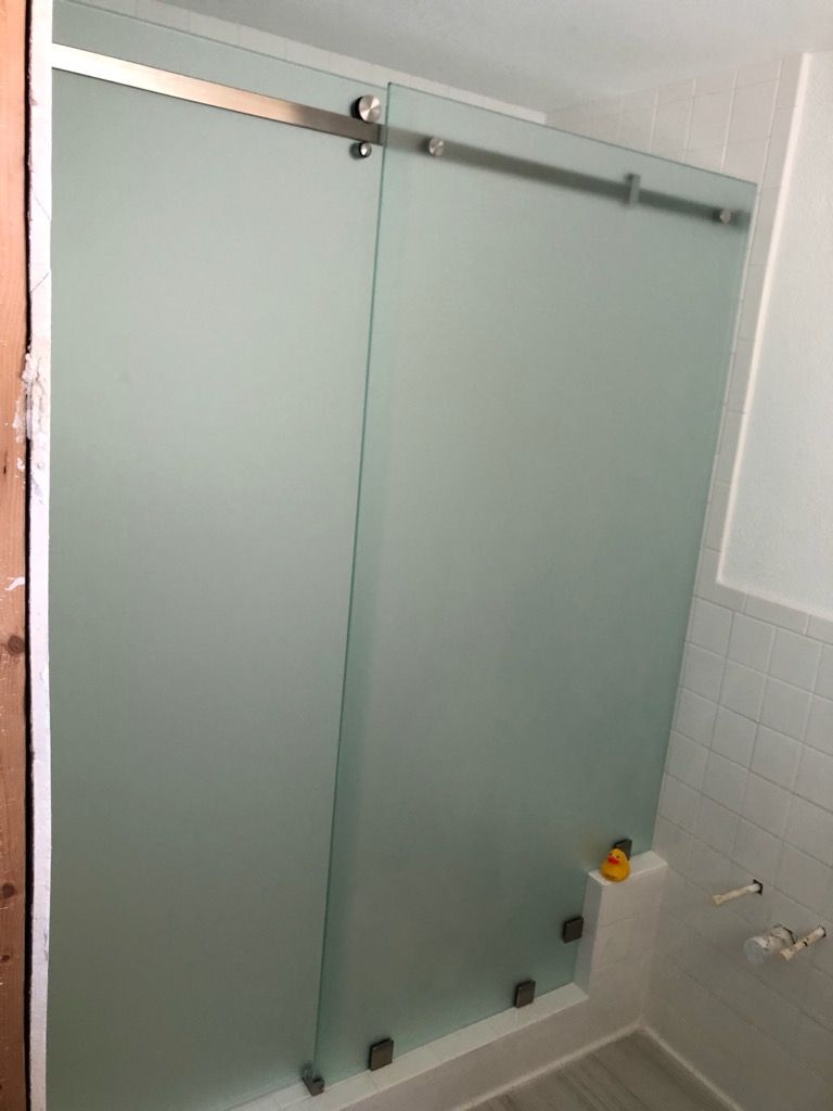 Sliding shower enclosure