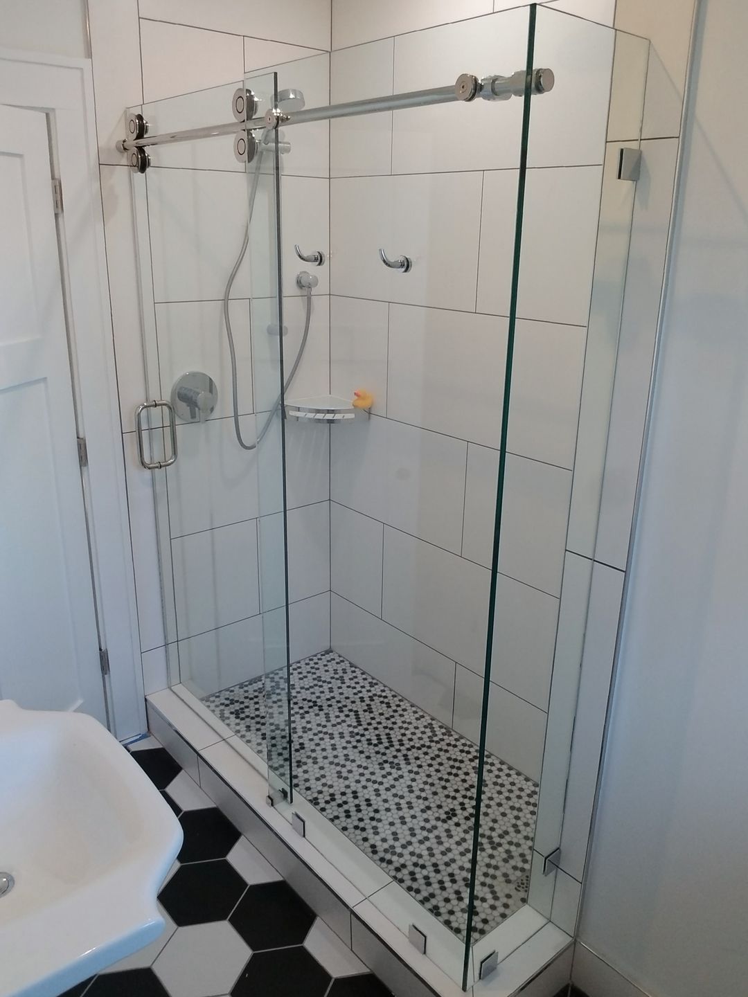 Sliding shower enclosure