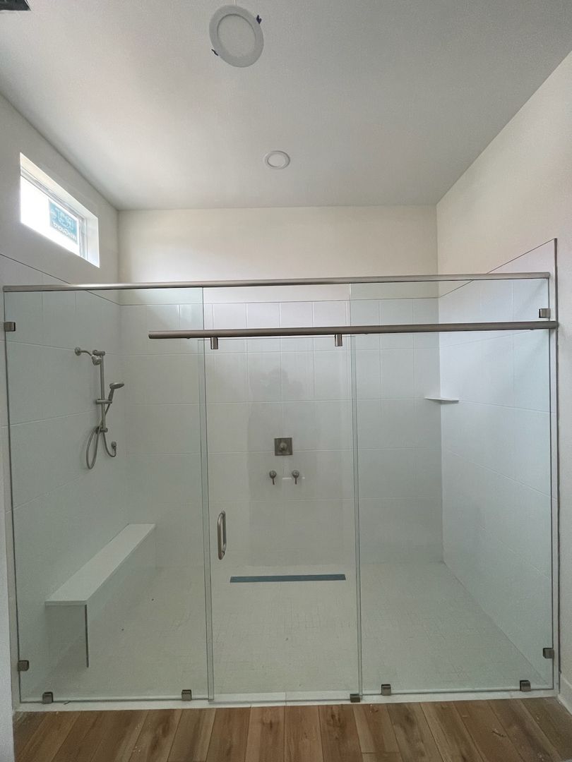 Sliding shower enclosure