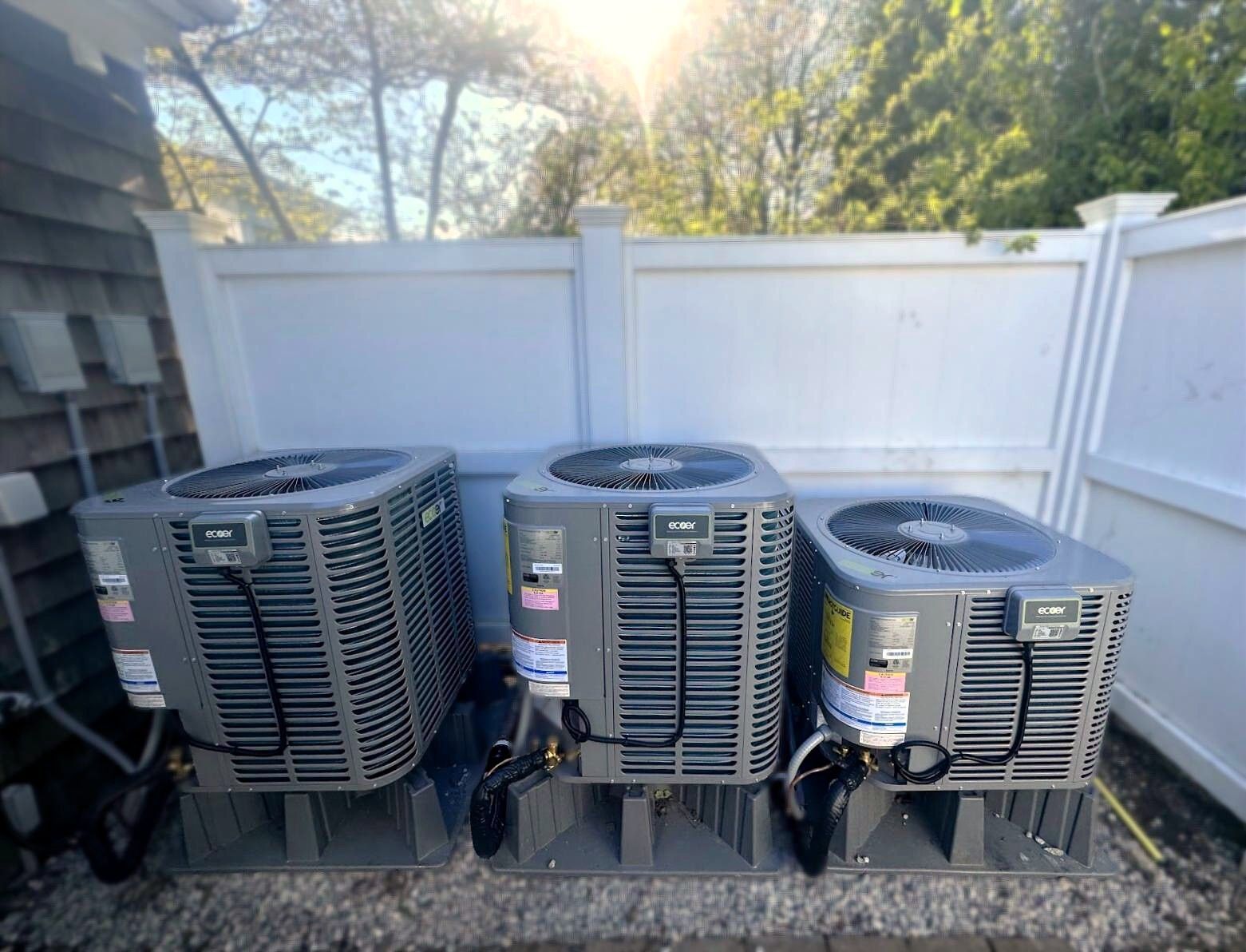 Industrial HVAC ducting and metal ventilation unit mounted in a mechanical room.