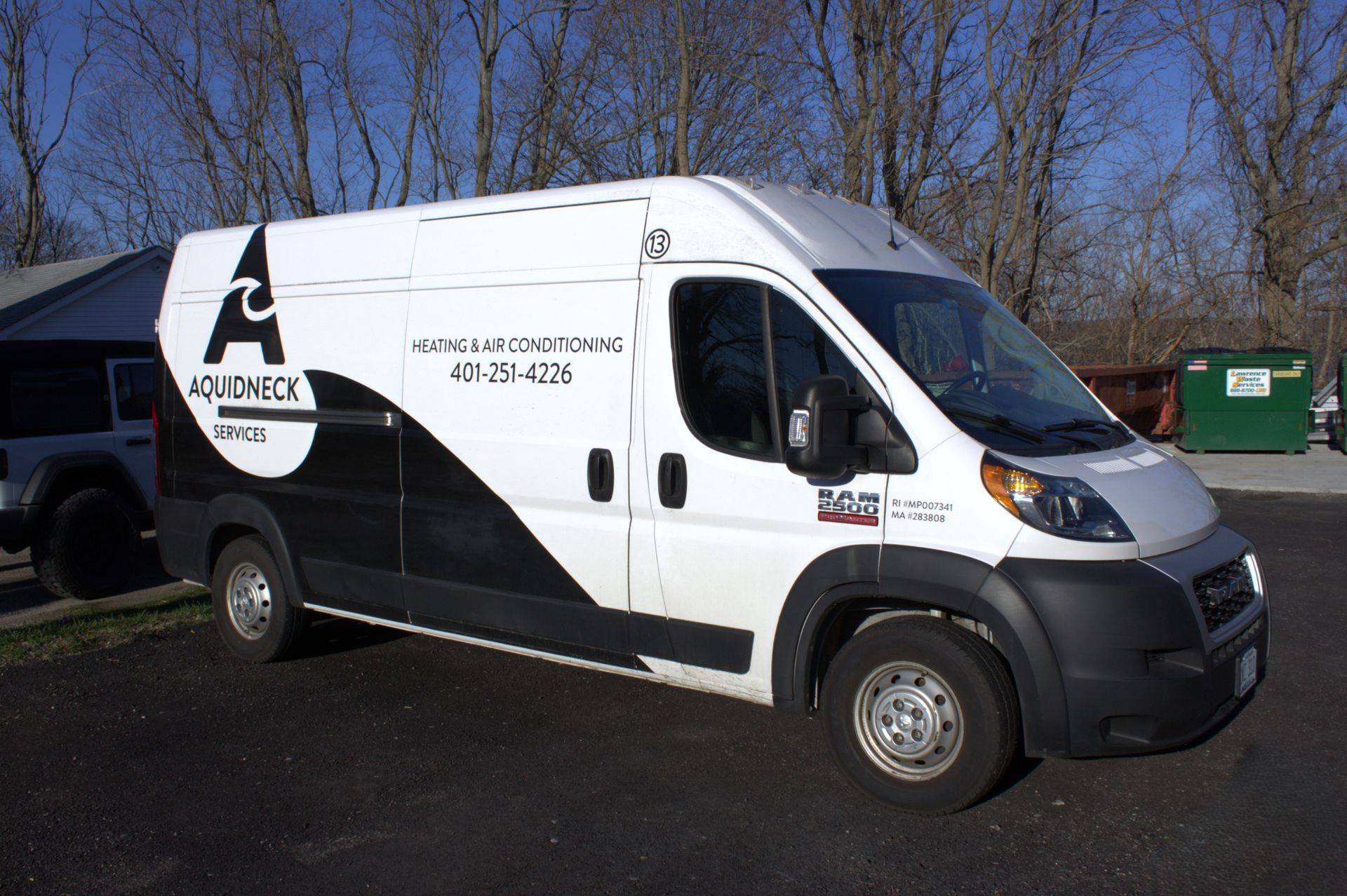 White and black delivery van parked outdoors on a sunny day