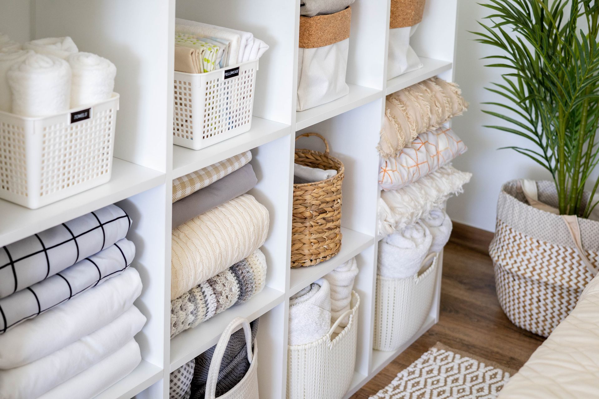 A closet filled with lots of towels and baskets.