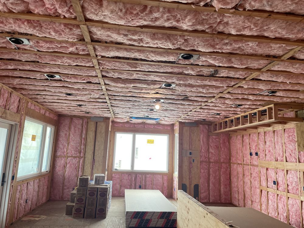 A room with pink insulation on the walls and ceiling.