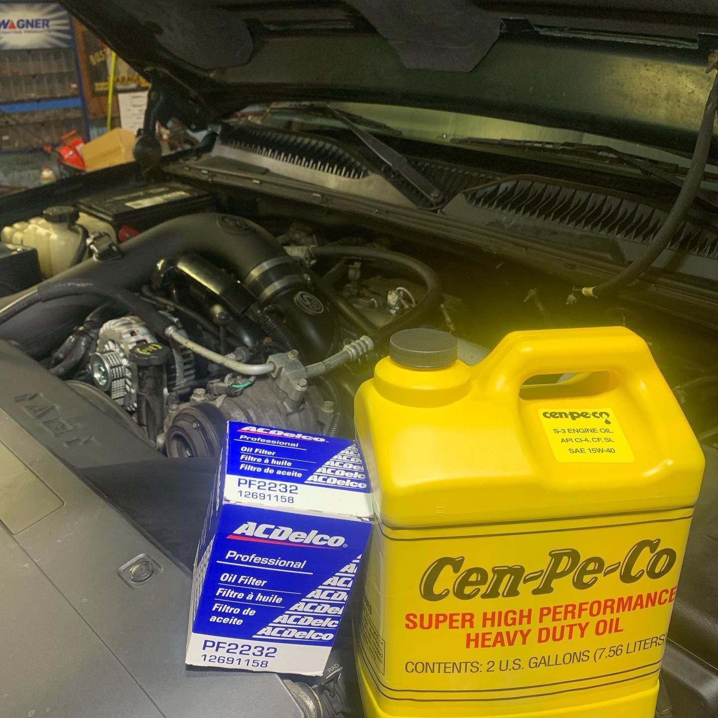 Truck engine bay with oil and filter; maintenance is in progress. Truck engine bay with oil and filter; maintenance is in progress.