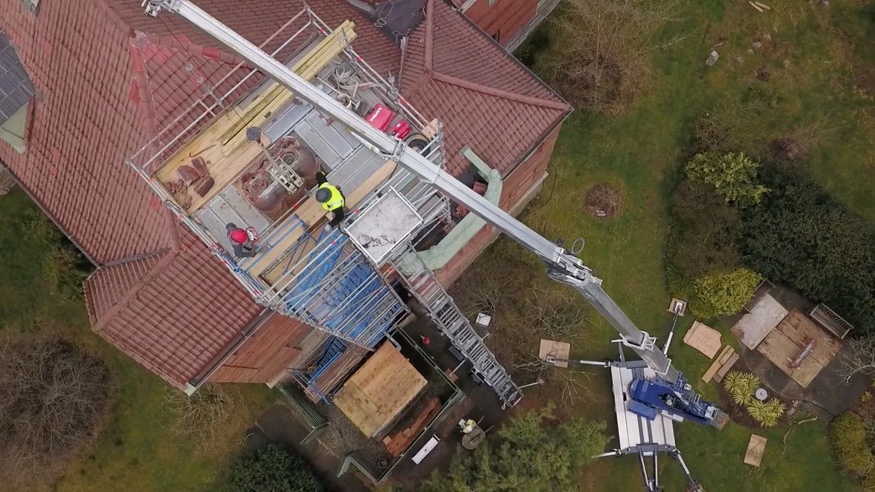 Trailer mounted crane for roofing 