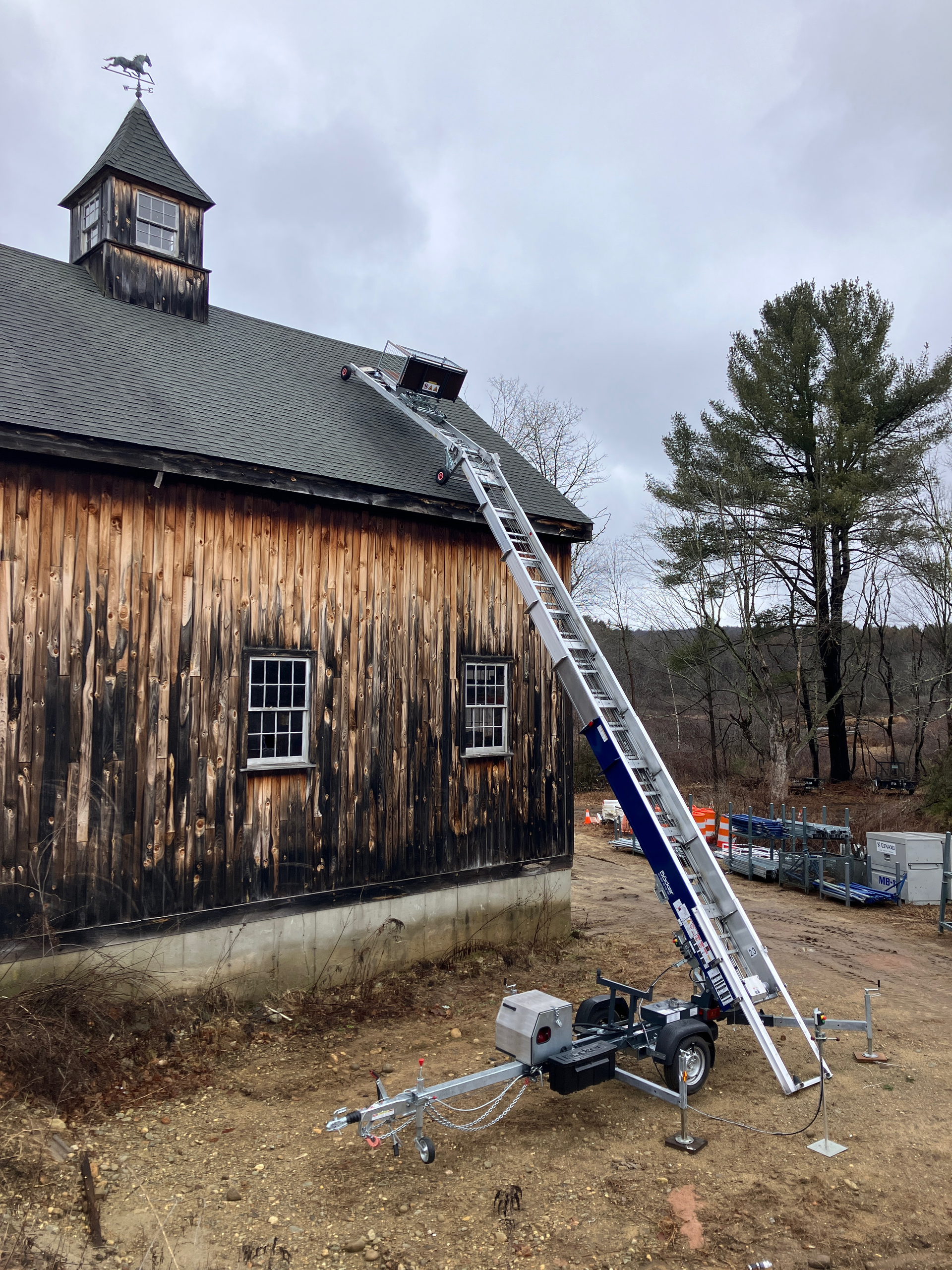 Comparison of ladder lift and inclined material hoist on roofing jobsites
