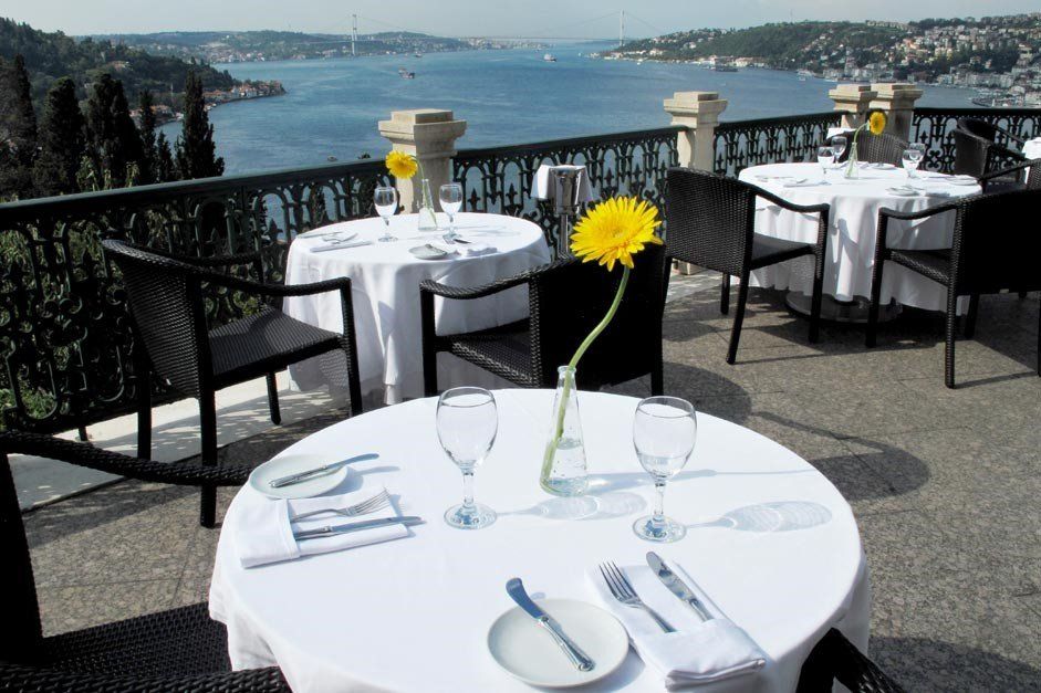 A table with a vase of yellow flowers on it