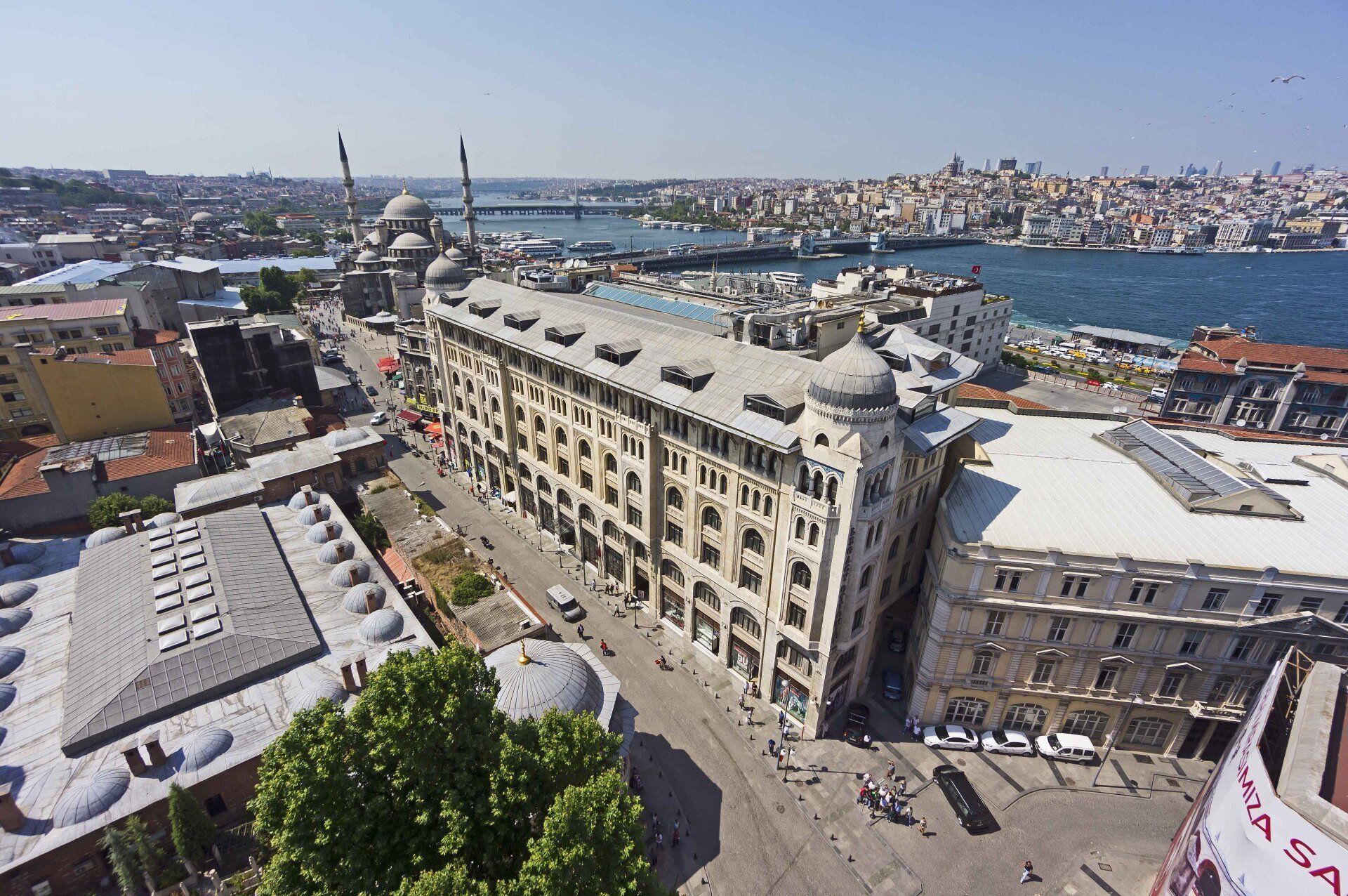 An aerial view of a city with a large building in the middle