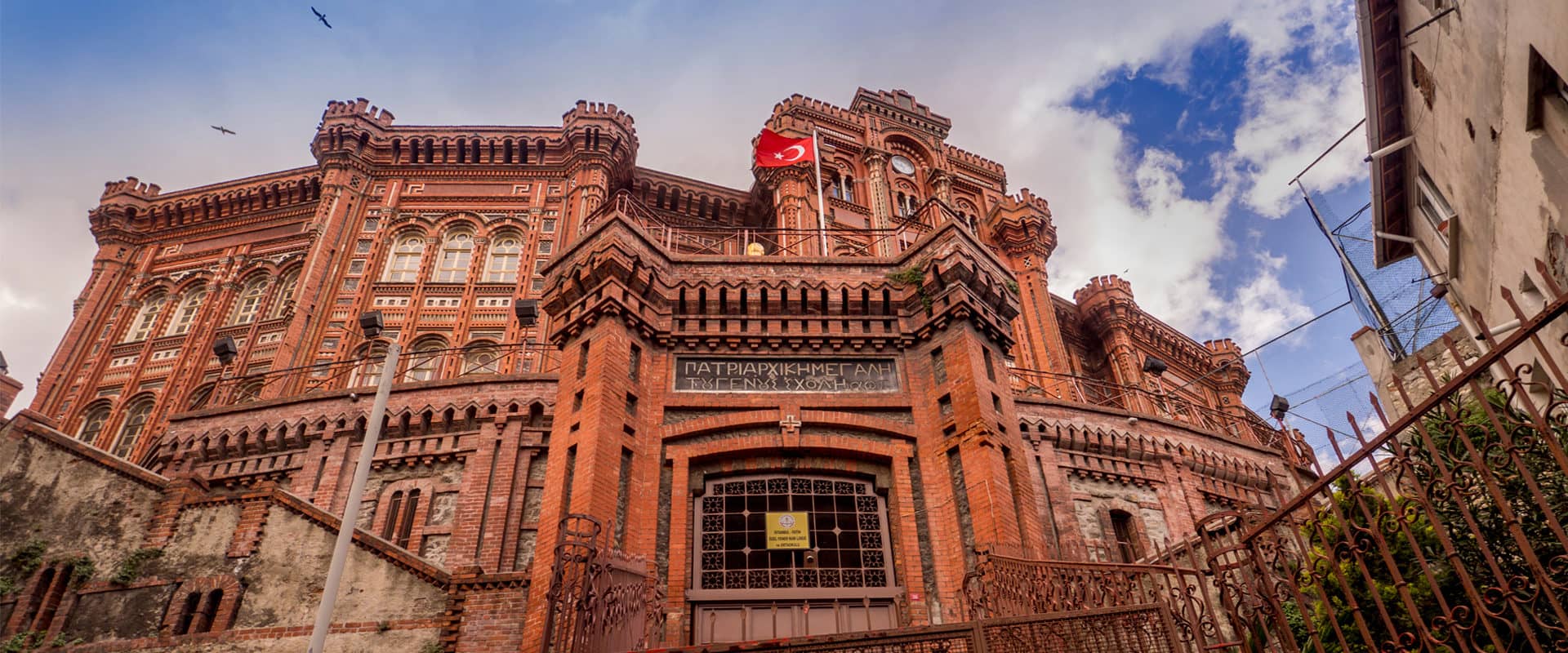 A large brick building with a flag on top of it.