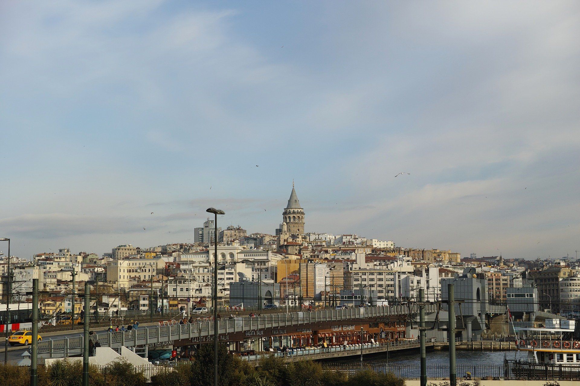 A city with a bridge in the foreground and a tower in the background