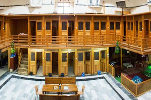 A large building with a lot of wooden doors and balconies.