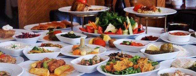 A table topped with plates and bowls of food.