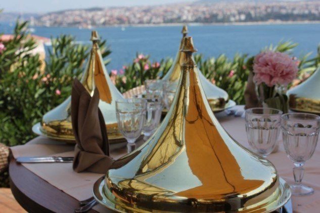 A table set for a meal with a view of the ocean