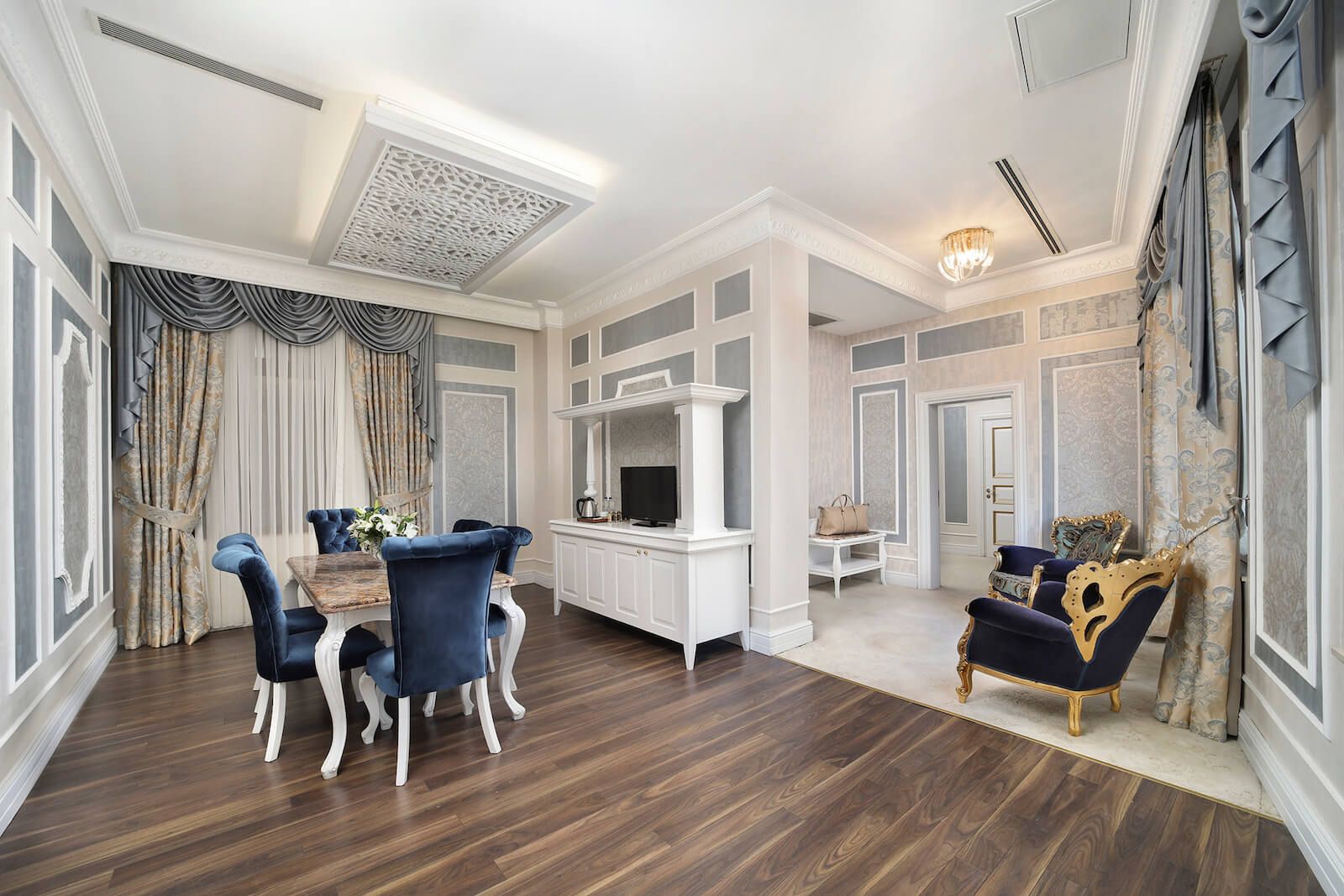 There is a dining table and chairs in the middle of the room.