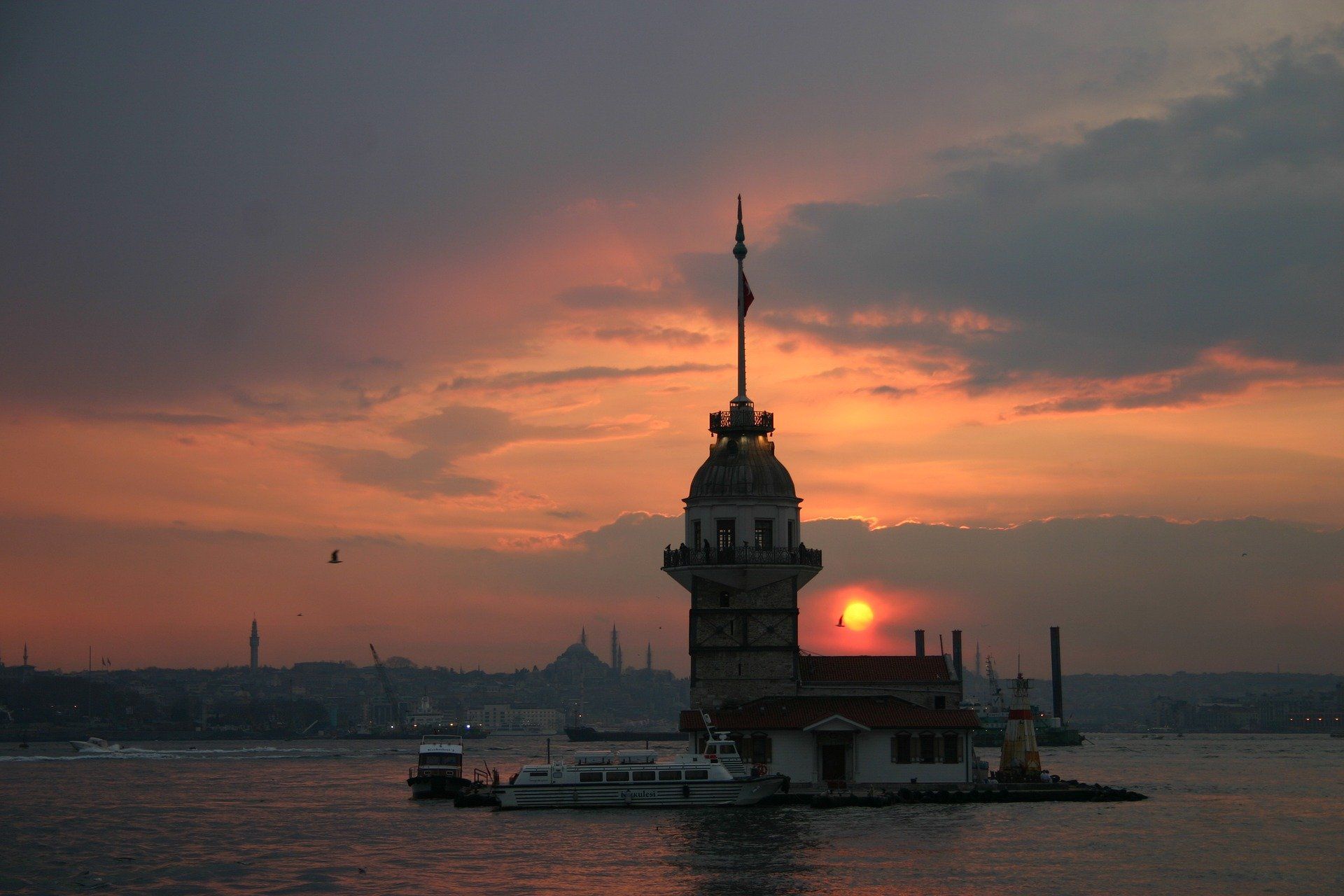 A tower in the middle of a body of water at sunset, Maidens Tower