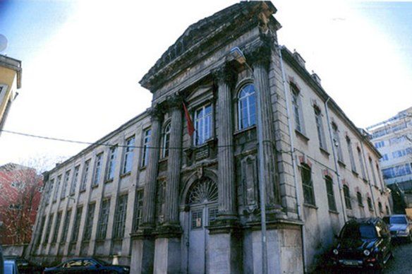 A large building with cars parked in front of it