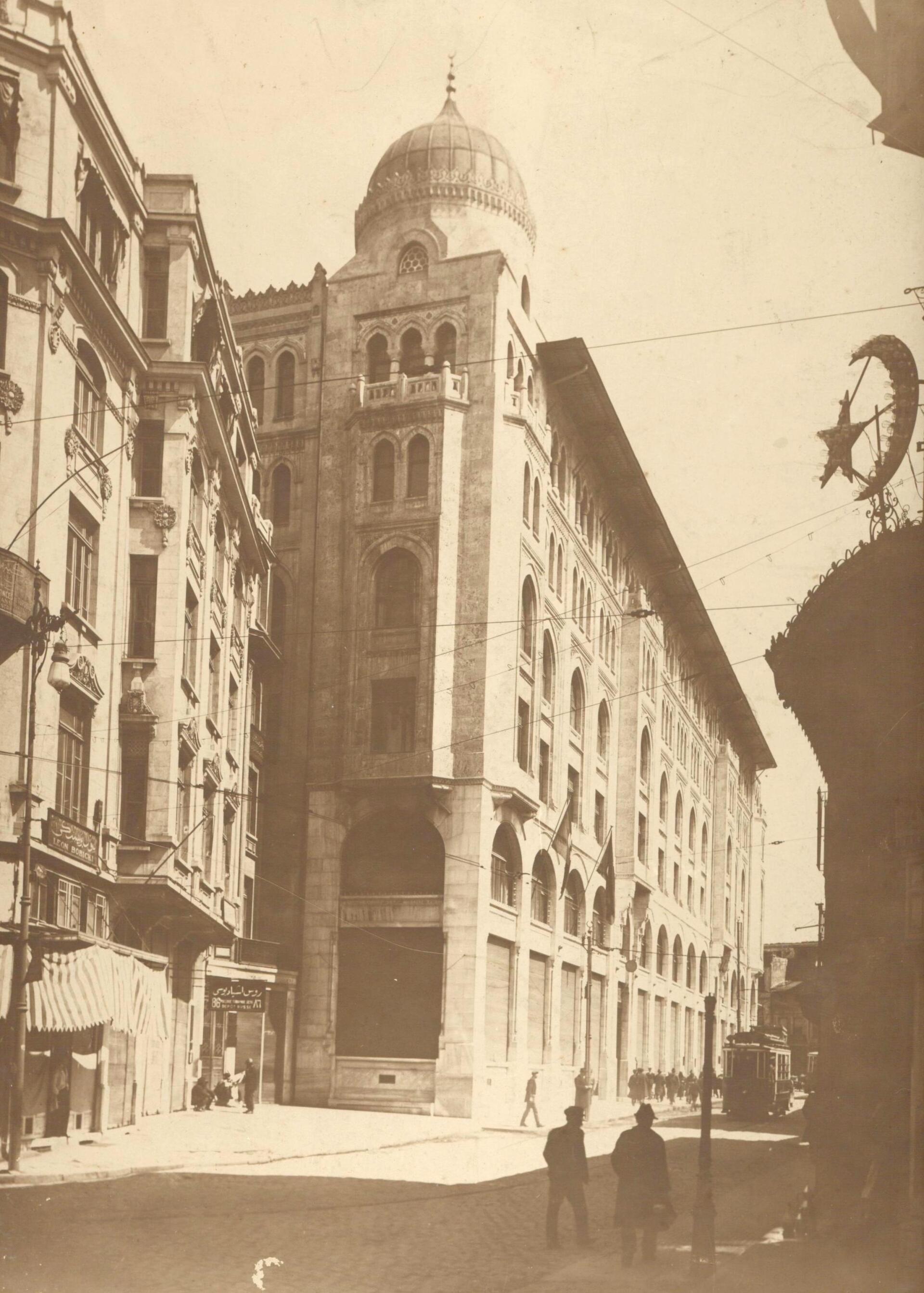 A black and white photo of a building with a dome on top