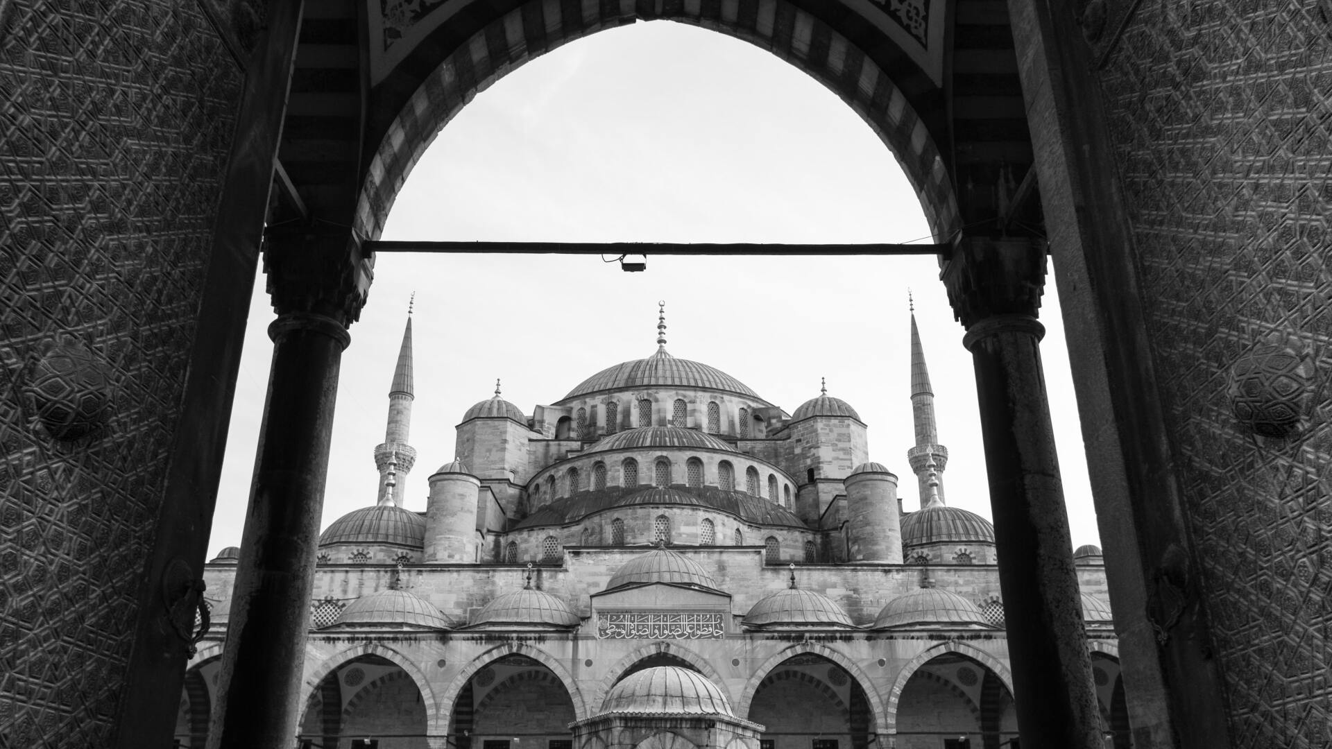 Blue Mosque, A black and white photo of a mosque taken through an archway.